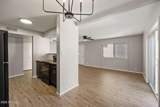 a kitchen with stainless steel appliances granite countertop a refrigerator and a stove
