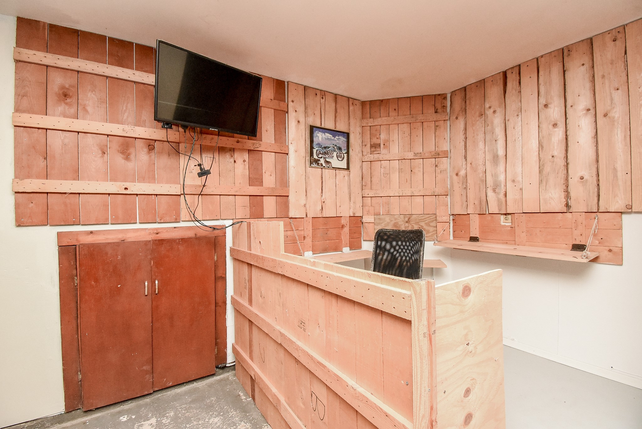 8715 Vinkins Road Houston, TX 77071 - Photo 46 of 48 The garage features a built-in workstation with ample desk space and storage, creating the perfect area for hobbies, DIY projects, crafts, or a dedicated workspace
