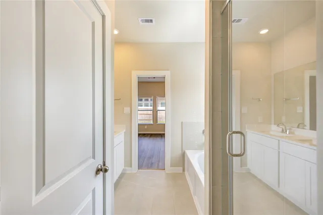 a bathroom with a tub and shower