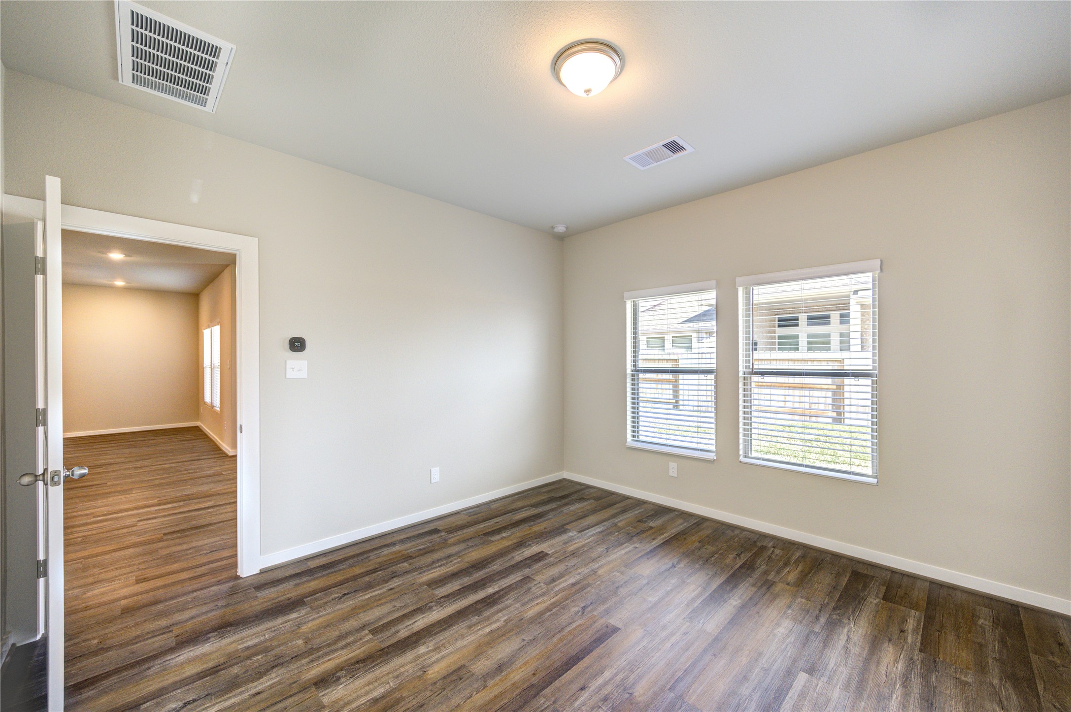 6219 Lost Rdg Lane Richmond, TX 77469 - Photo 33 of 50 a view of an empty room with wooden floor and a window