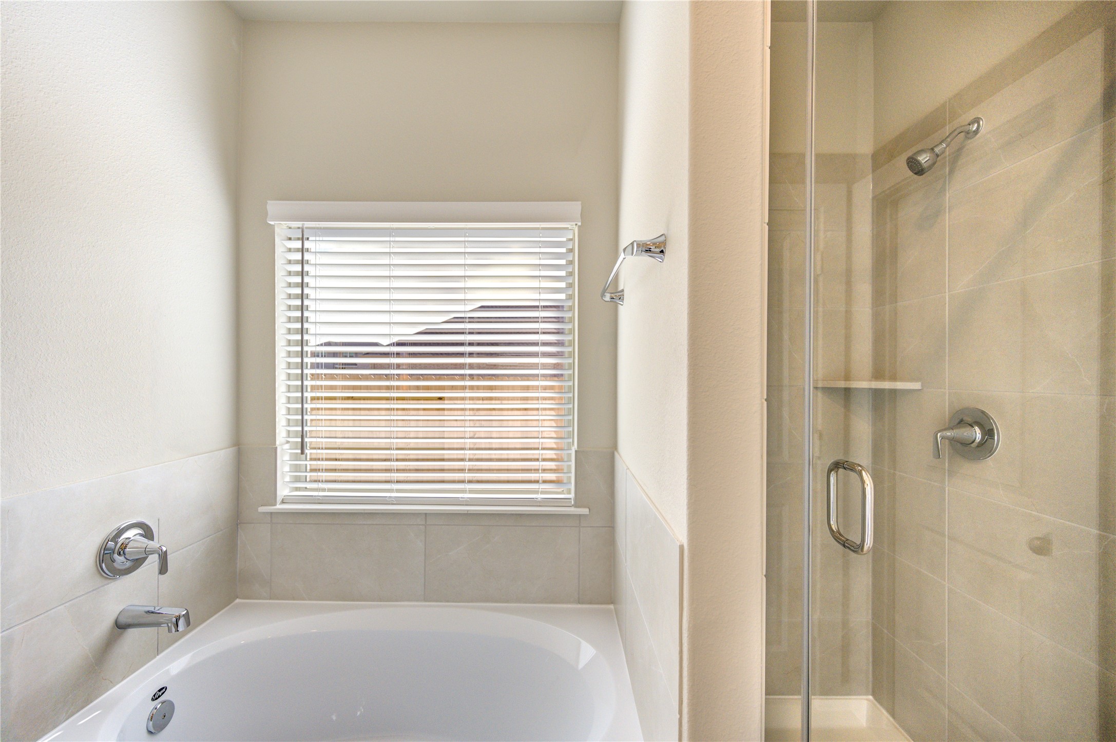 6219 Lost Rdg Lane Richmond, TX 77469 - Photo 36 of 50 a bathroom with a tub shower and a window