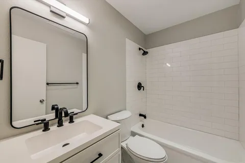 a bathroom with a sink toilet tub and shower
