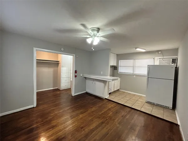 a view of a kitchen with a sink and a refrigerator