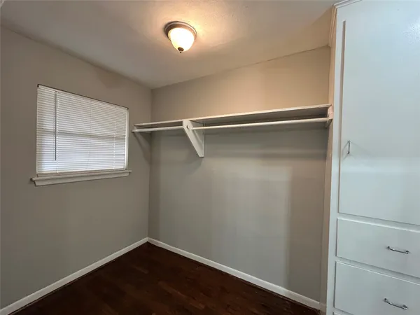 a view of a room with wooden floor and closet