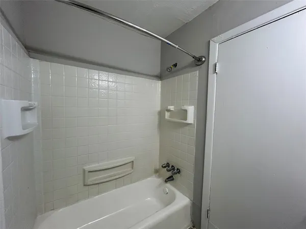 a bathroom with a shower and a bath tub