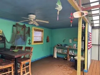 a view of a room with a table and a chandelier