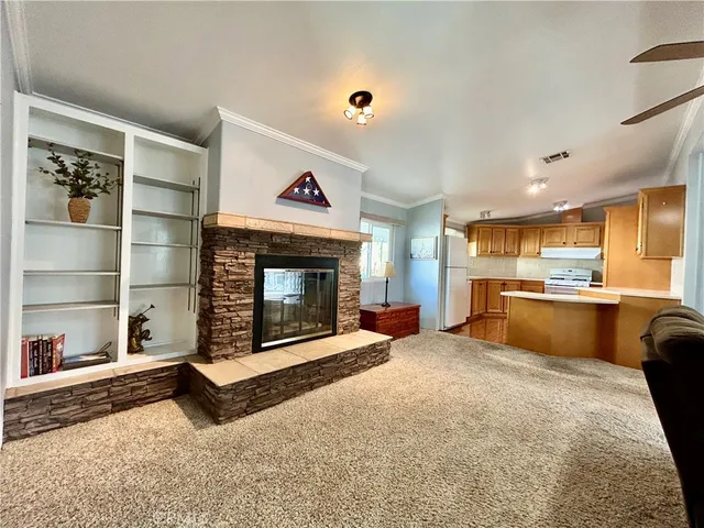 a kitchen with stainless steel appliances granite countertop a sink a stove cabinets and wooden floor