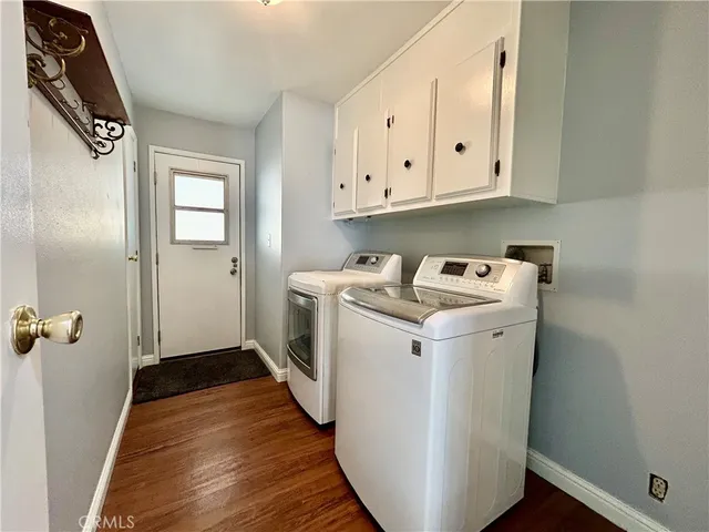 a bed sitting in a spacious bedroom next to a window