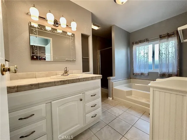 a bathroom with a tub shower and a sink