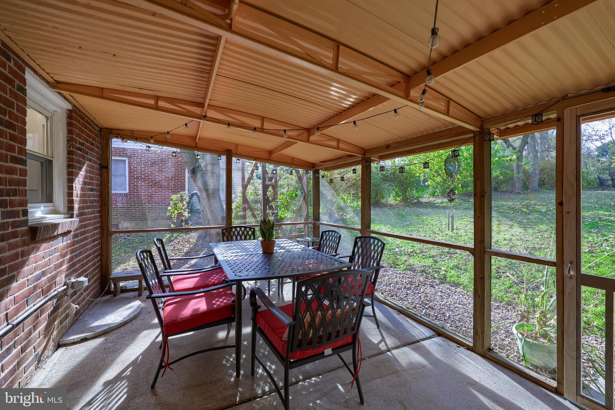 20 Willis Lane Lancaster, PA 17602 - Photo 38 of 39 a view of a patio with table and chairs under an umbrella with a small yard