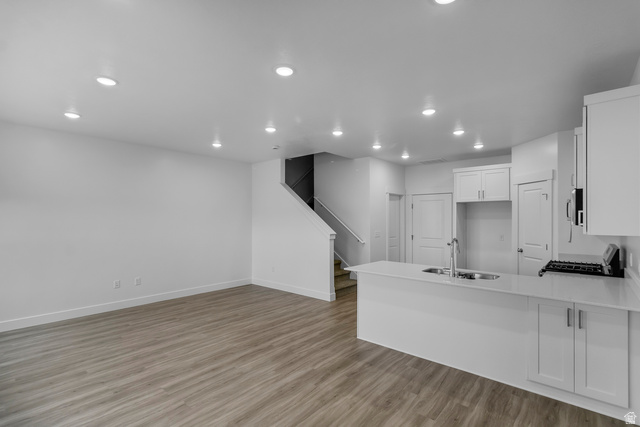 3014 South 265th Street West Logan, UT 84321 - Photo 3 of 25 Open-concept living area with wood-finish flooring, recessed lighting, and a modern kitchen