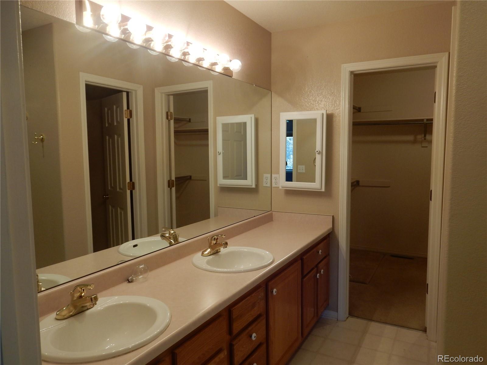 4324 Quail Street Wheat Ridge, CO 80033 - Photo 16 of 30 a bathroom with a sink double vanity and a mirror