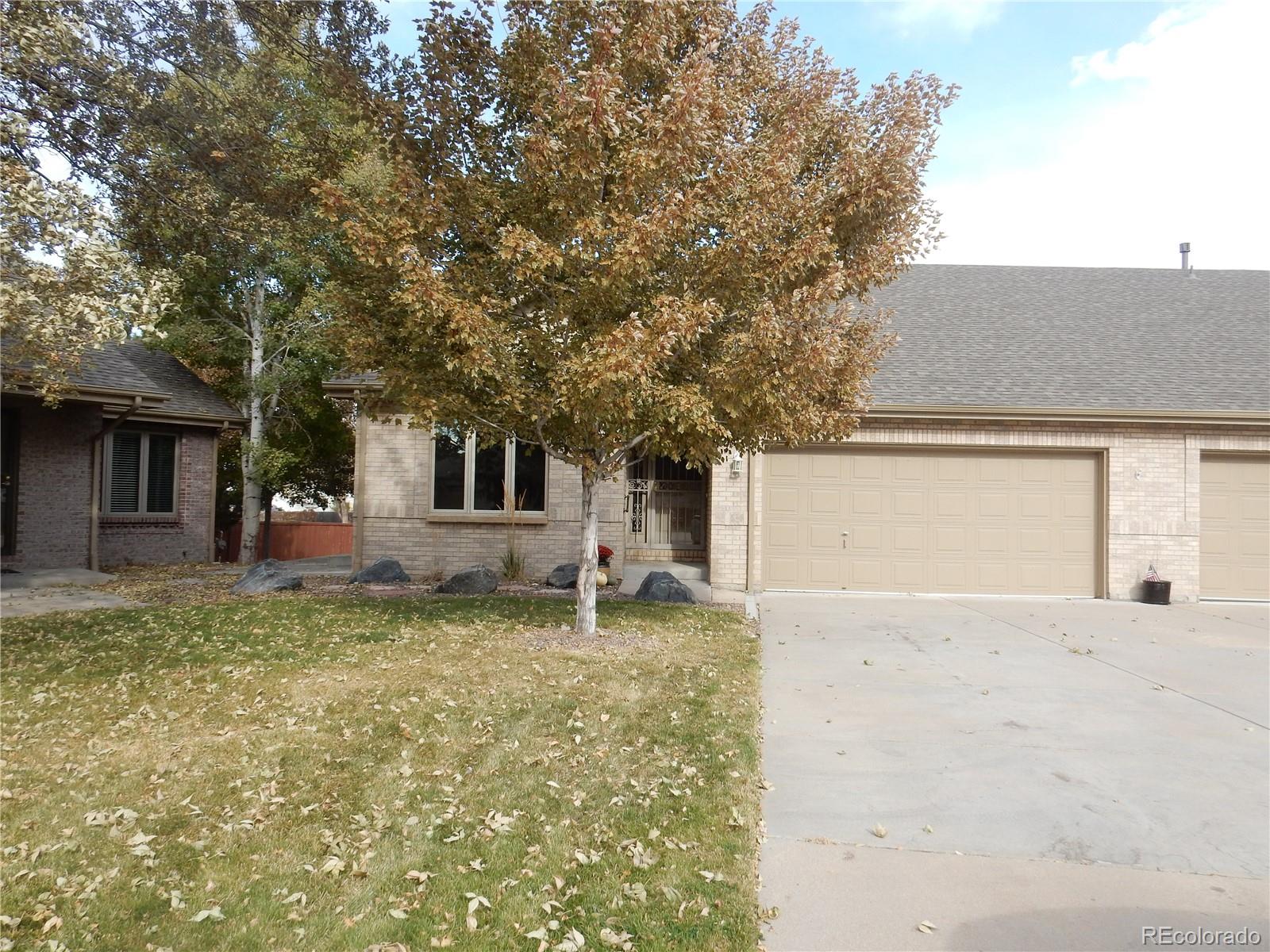 4324 Quail Street Wheat Ridge, CO 80033 - Photo 2 of 30 a front view of a house with a yard and garage