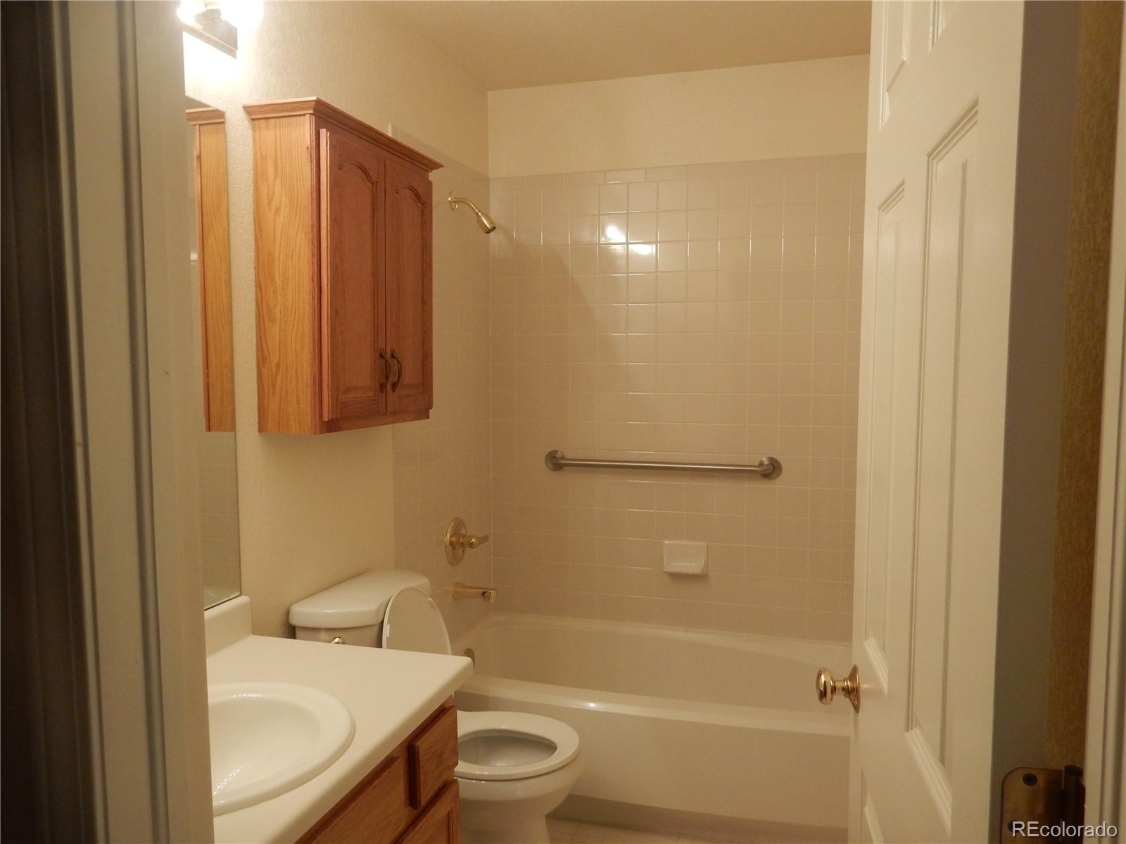 4324 Quail Street Wheat Ridge, CO 80033 - Photo 22 of 30 a bathroom with a sink toilet and shower