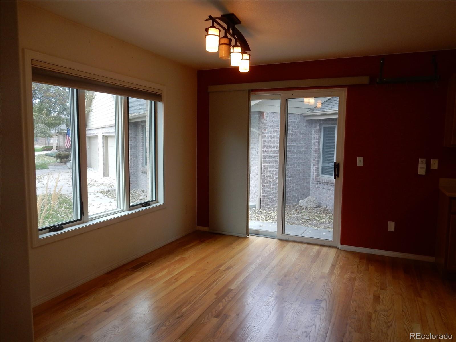4324 Quail Street Wheat Ridge, CO 80033 - Photo 7 of 30 a view of an empty room with wooden floor and a window