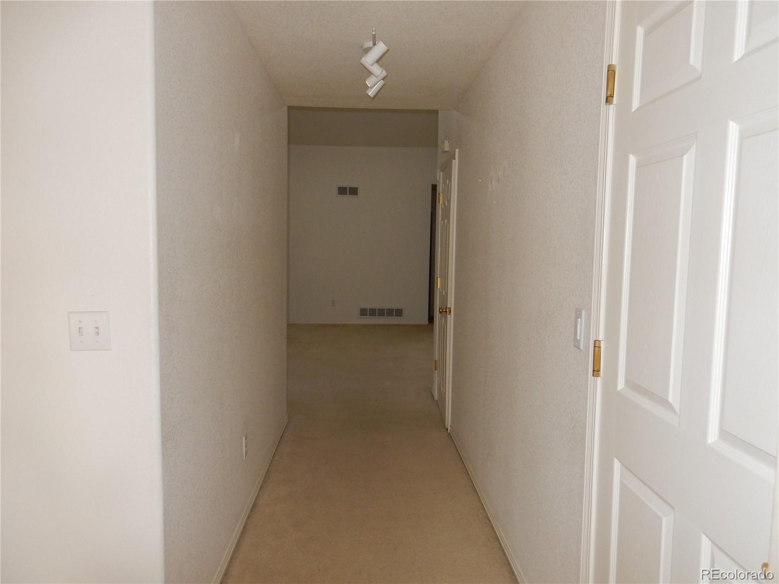 4324 Quail Street Wheat Ridge, CO 80033 - Photo 8 of 30 a view of a hallway with closet