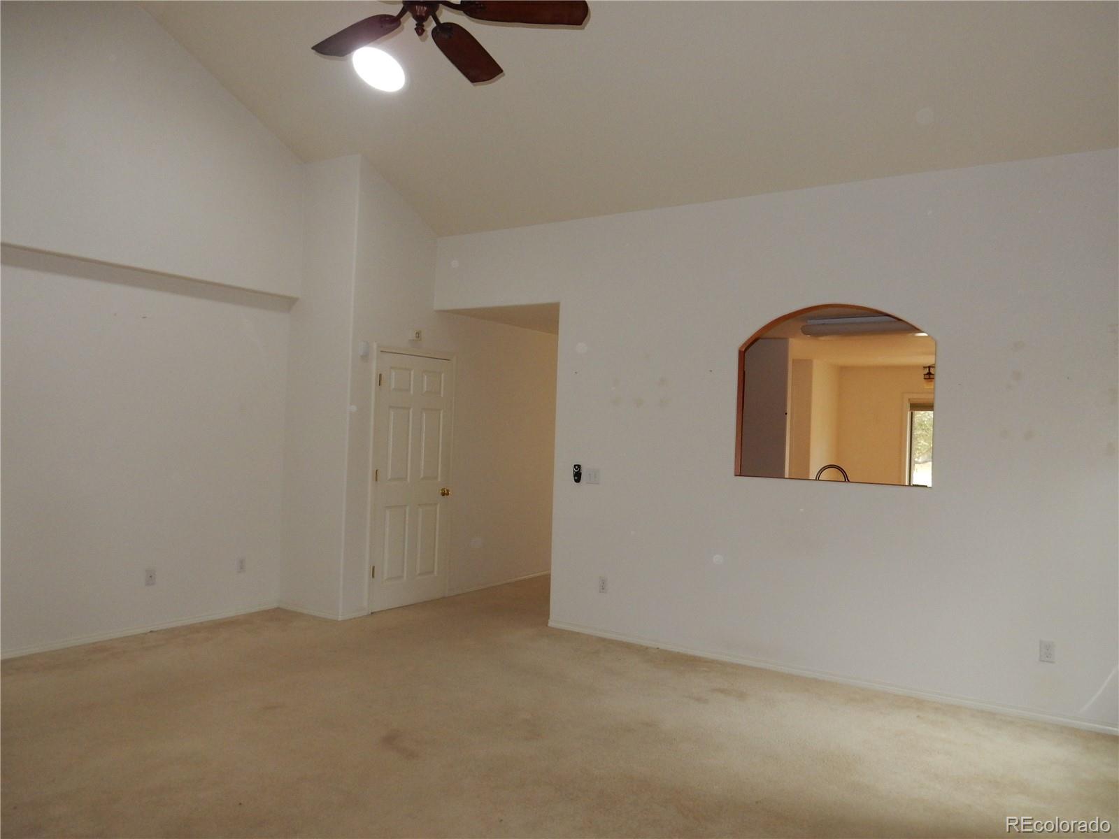 4324 Quail Street Wheat Ridge, CO 80033 - Photo 9 of 30 a view of a livingroom with a ceiling fan and window