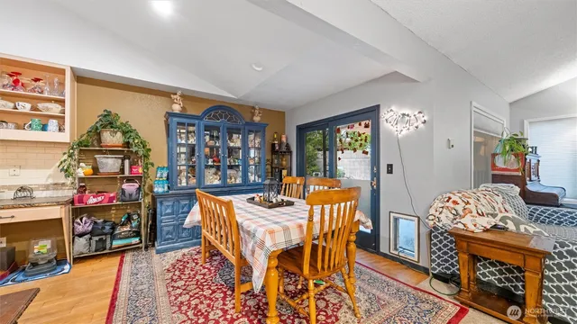 a living room with furniture a rug and a bookshelf