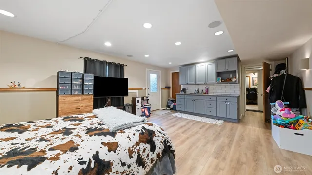 a bed room with a bed and a television