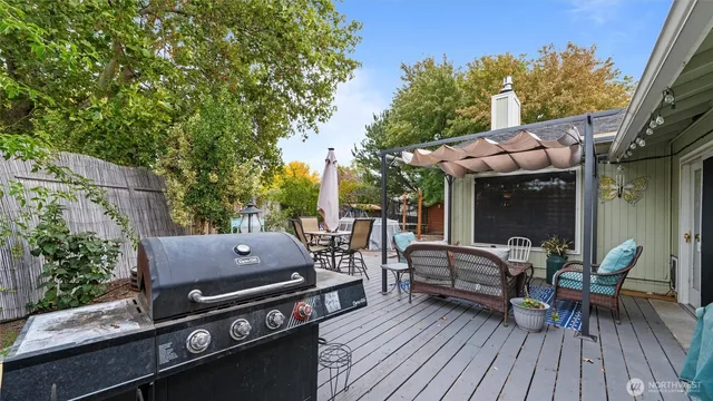 a view of a patio with table and chairs and wooden floor