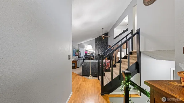 a view of entryway and hall with wooden floor