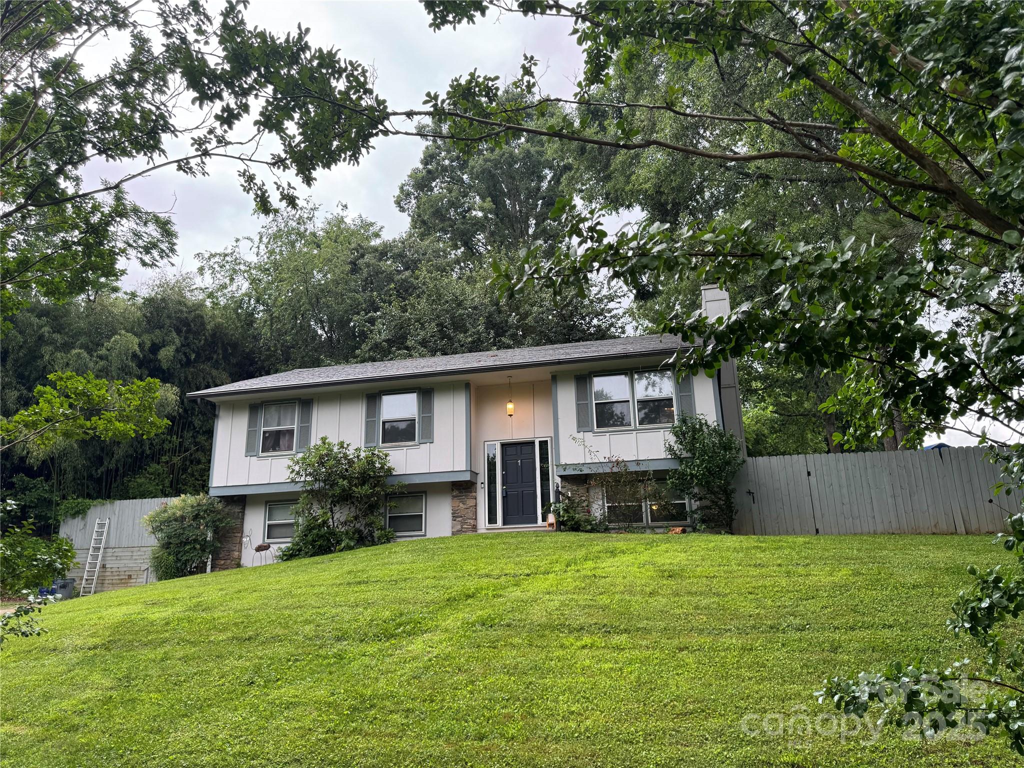 a front view of house with yard and trees