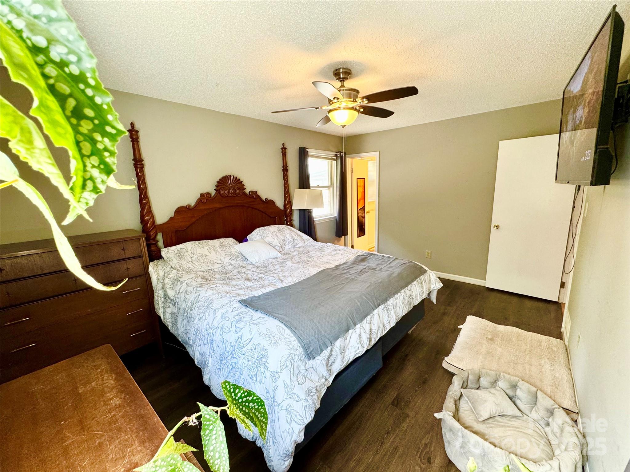 1 Spring Valley Drive Arden, NC 28704 - Photo 17 of 39 a bedroom with a bed and a chandelier