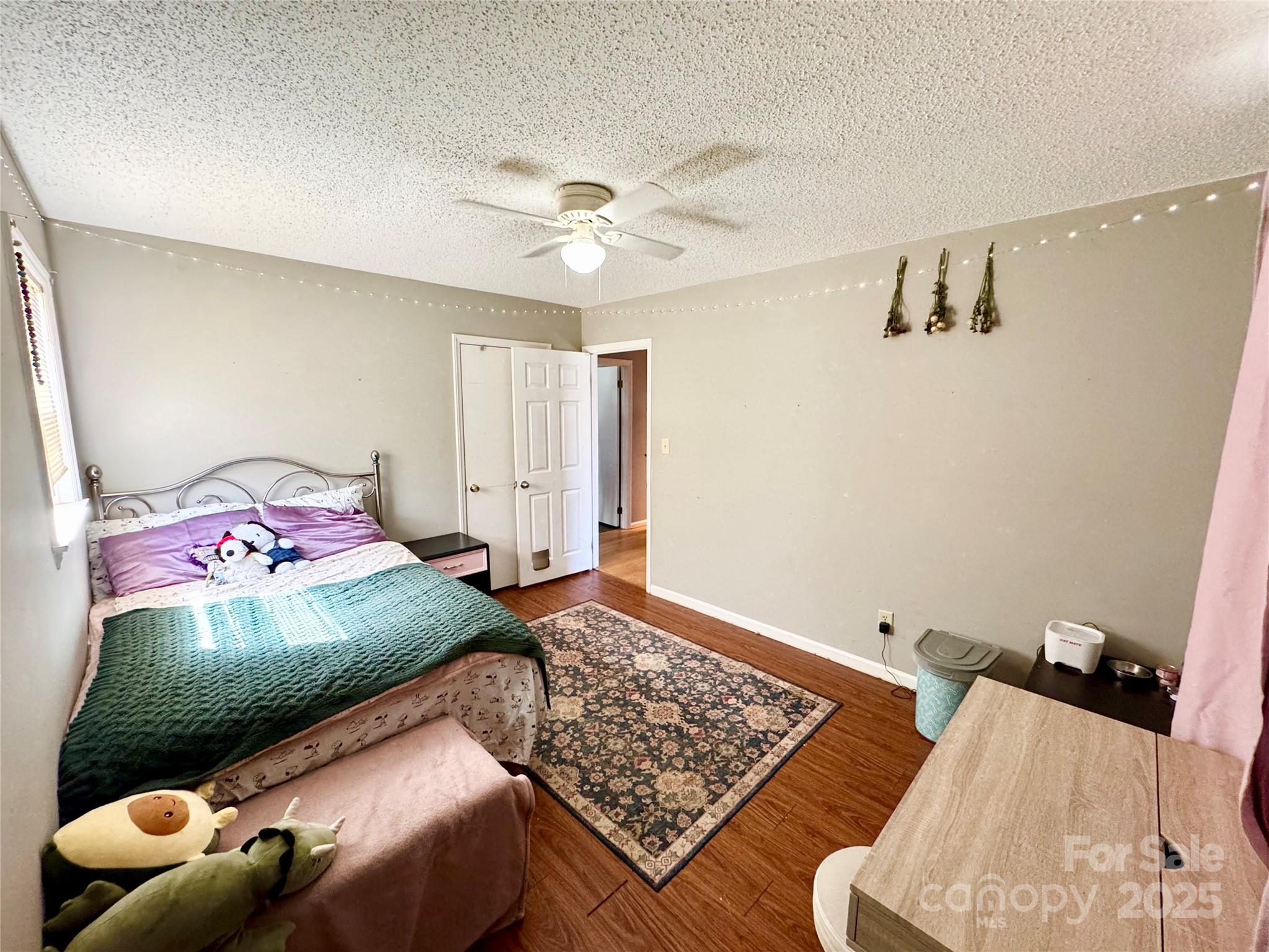 1 Spring Valley Drive Arden, NC 28704 - Photo 20 of 39 a bedroom with a bed and wooden floor
