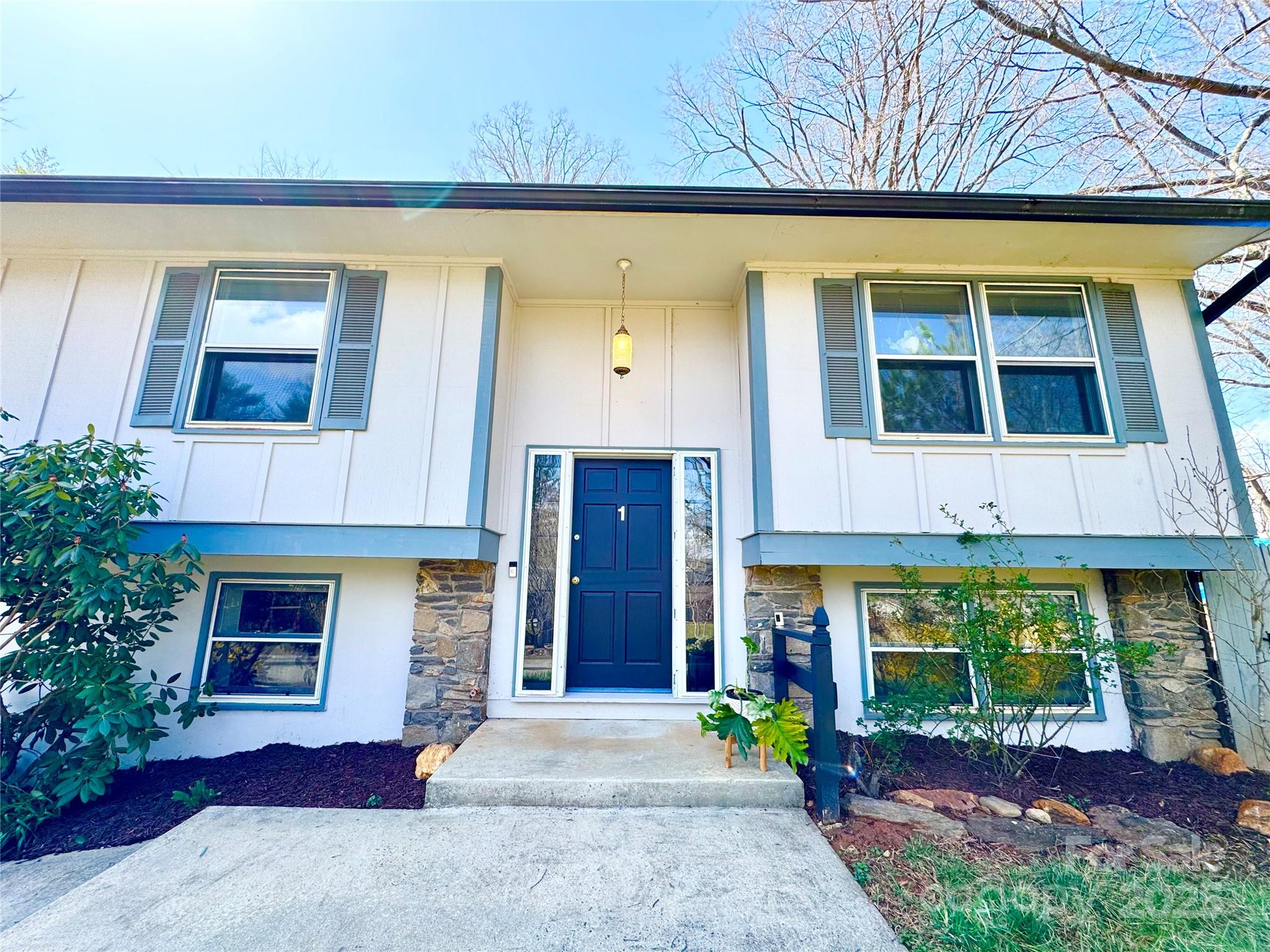 1 Spring Valley Drive Arden, NC 28704 - Photo 5 of 39 a front view of a house with a garden