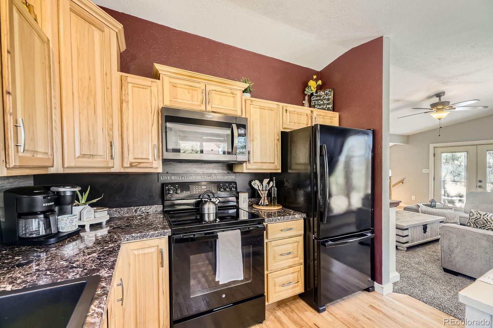 49 Silver Springs Road Bailey, CO 80421 - Photo 13 of 34 a kitchen with stainless steel appliances granite countertop a refrigerator stove and sink