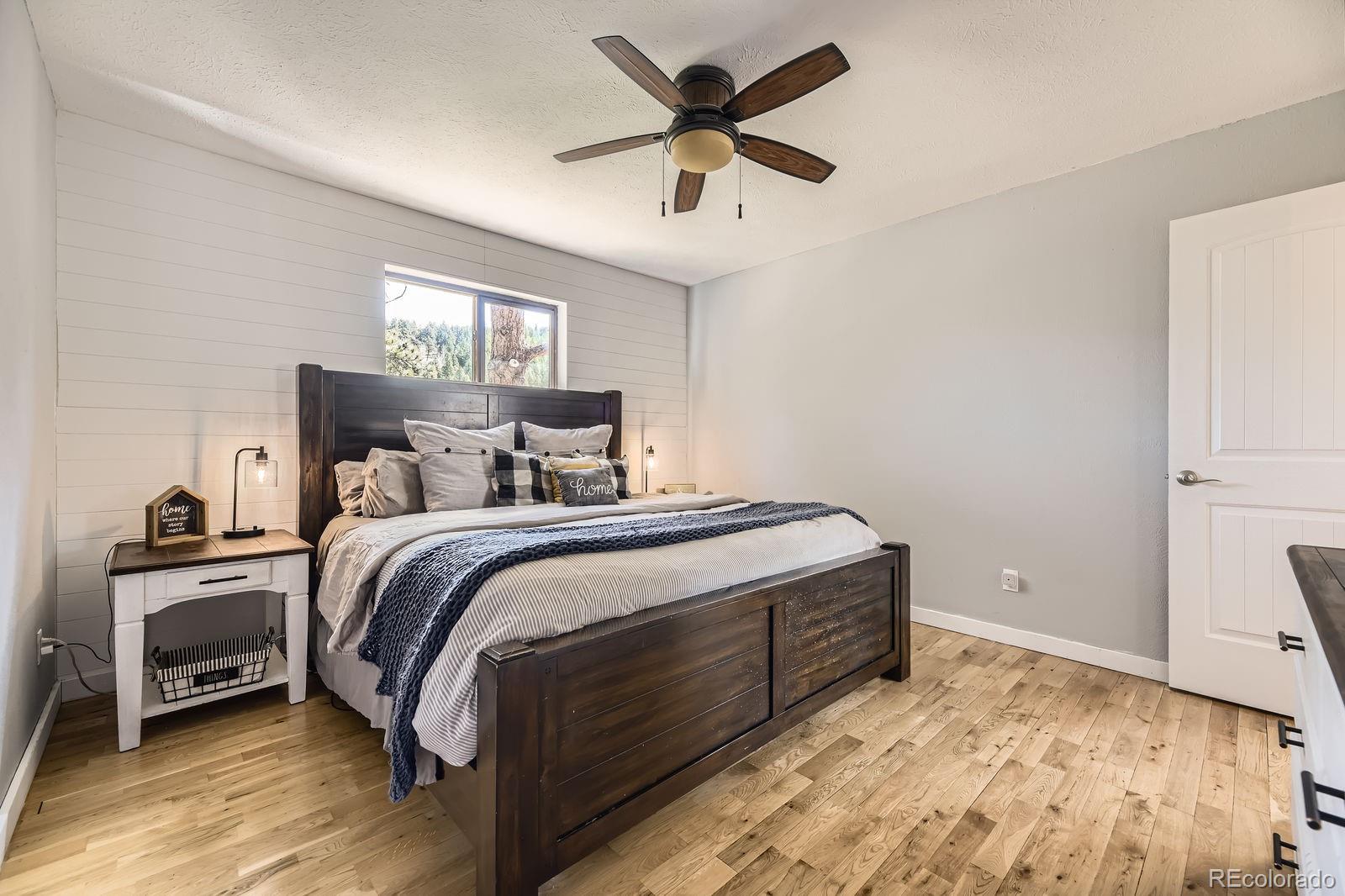 49 Silver Springs Road Bailey, CO 80421 - Photo 15 of 34 a bedroom with a bed and a ceiling fan