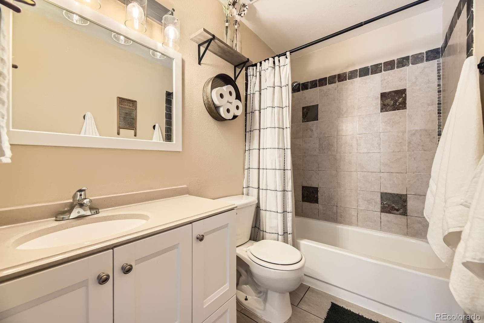49 Silver Springs Road Bailey, CO 80421 - Photo 16 of 34 a bathroom with a sink a toilet and a bathtub
