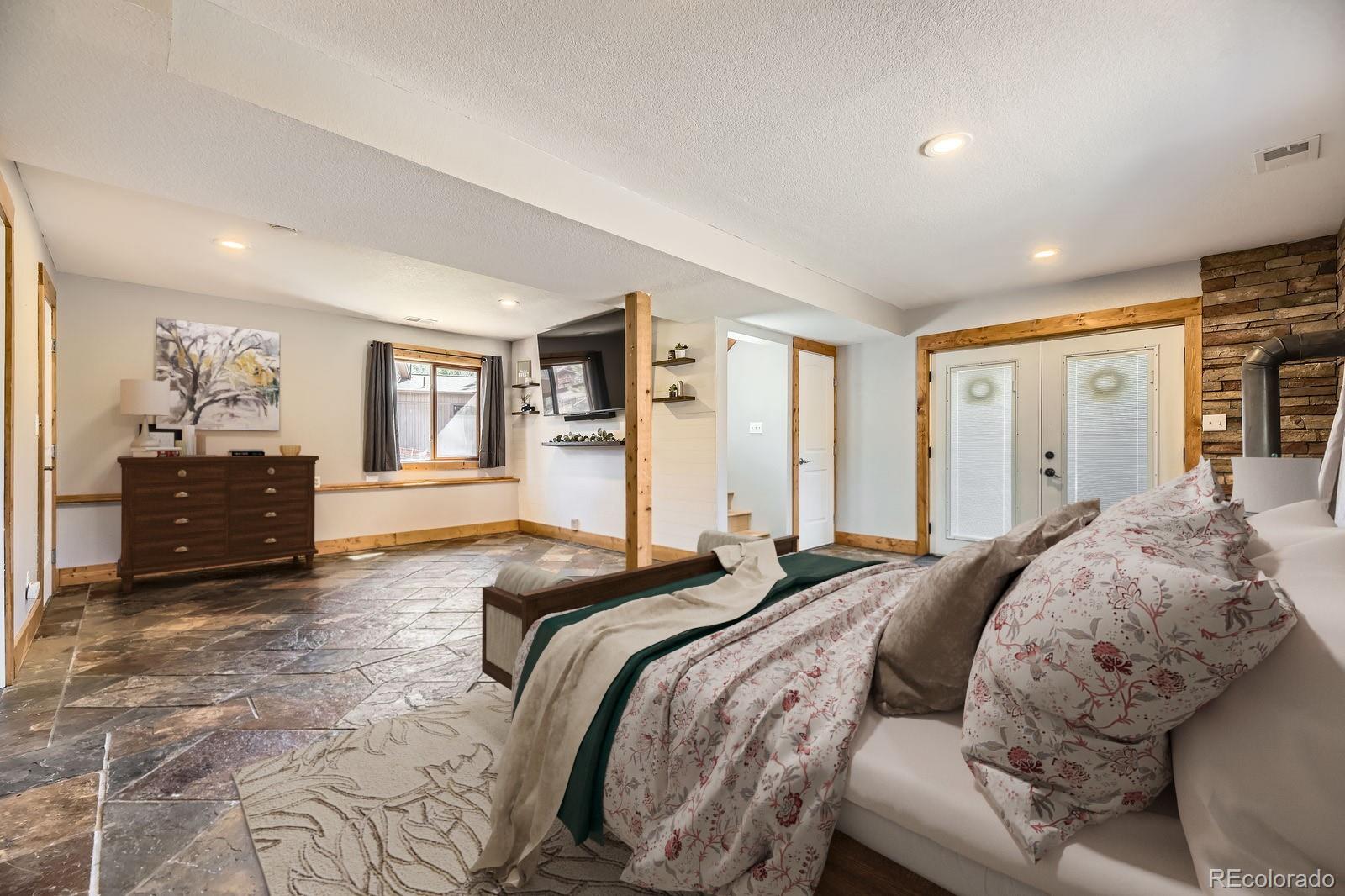 49 Silver Springs Road Bailey, CO 80421 - Photo 20 of 34 a spacious bedroom with a bed and dresser