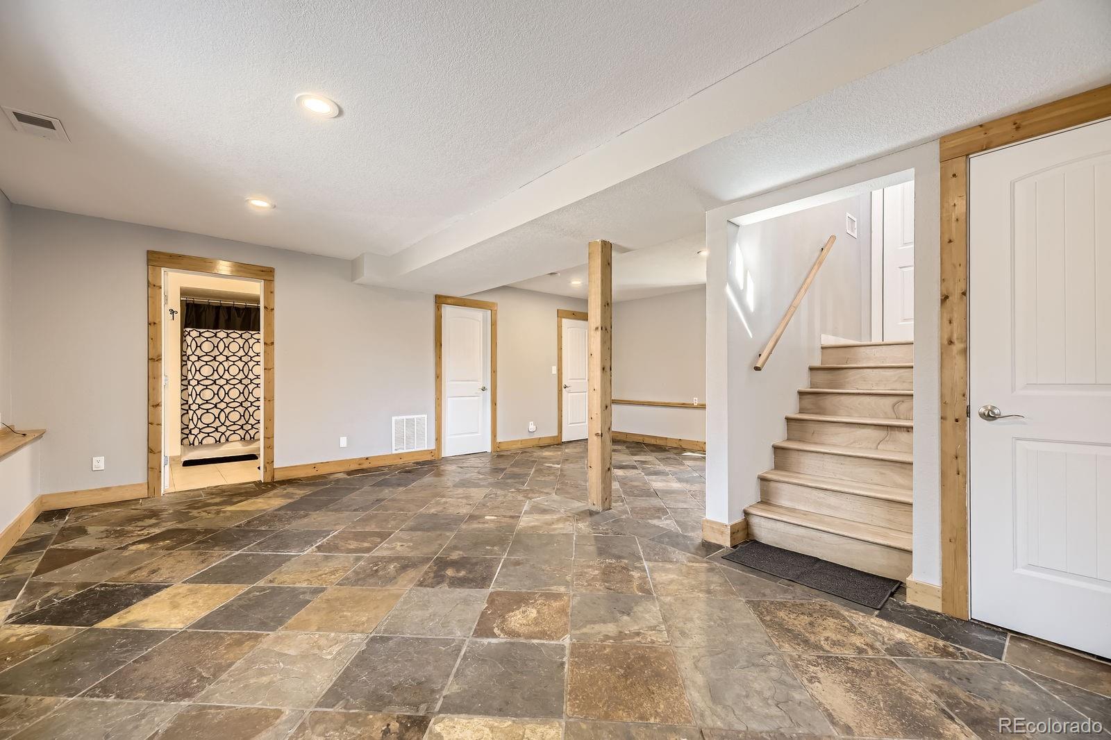 49 Silver Springs Road Bailey, CO 80421 - Photo 22 of 34 a view of a room with a staircase and white walls