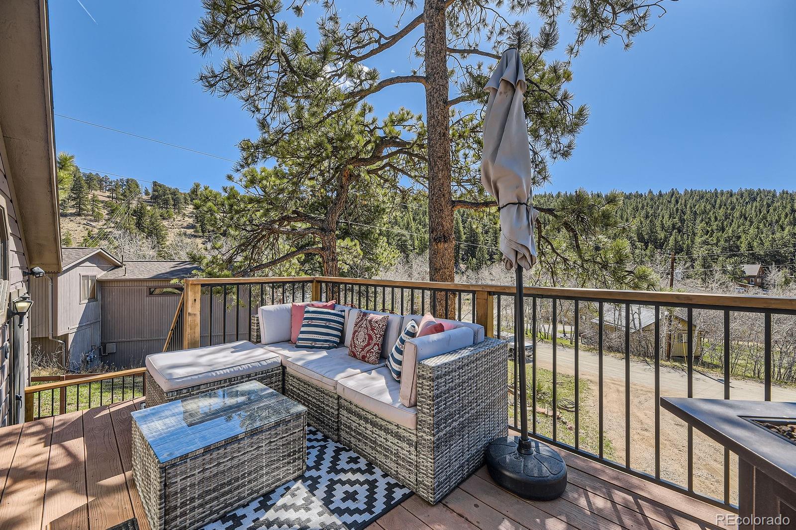 49 Silver Springs Road Bailey, CO 80421 - Photo 3 of 34 a view of a two chairs on the roof deck