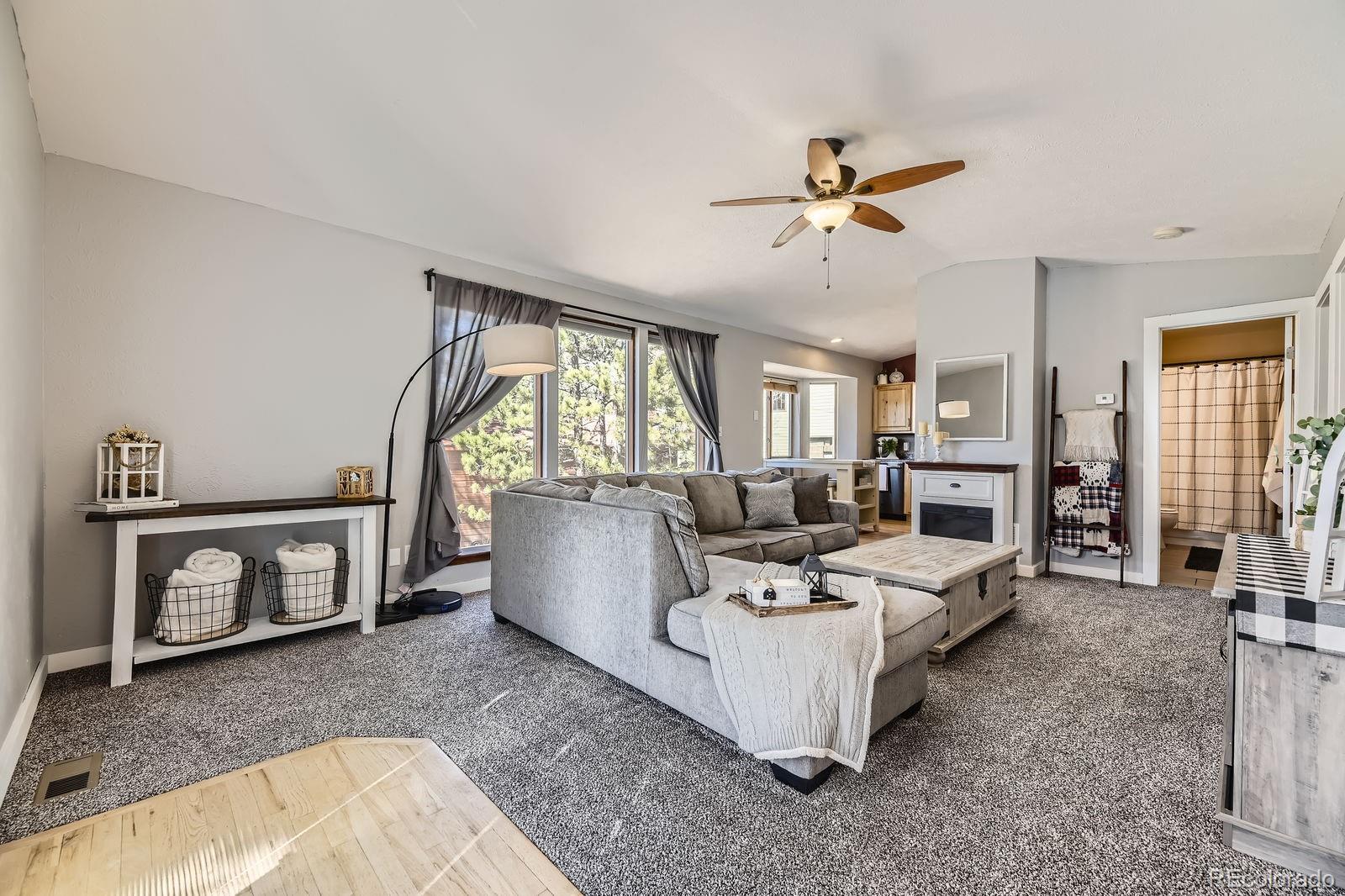 49 Silver Springs Road Bailey, CO 80421 - Photo 7 of 34 a living room with furniture and a fireplace