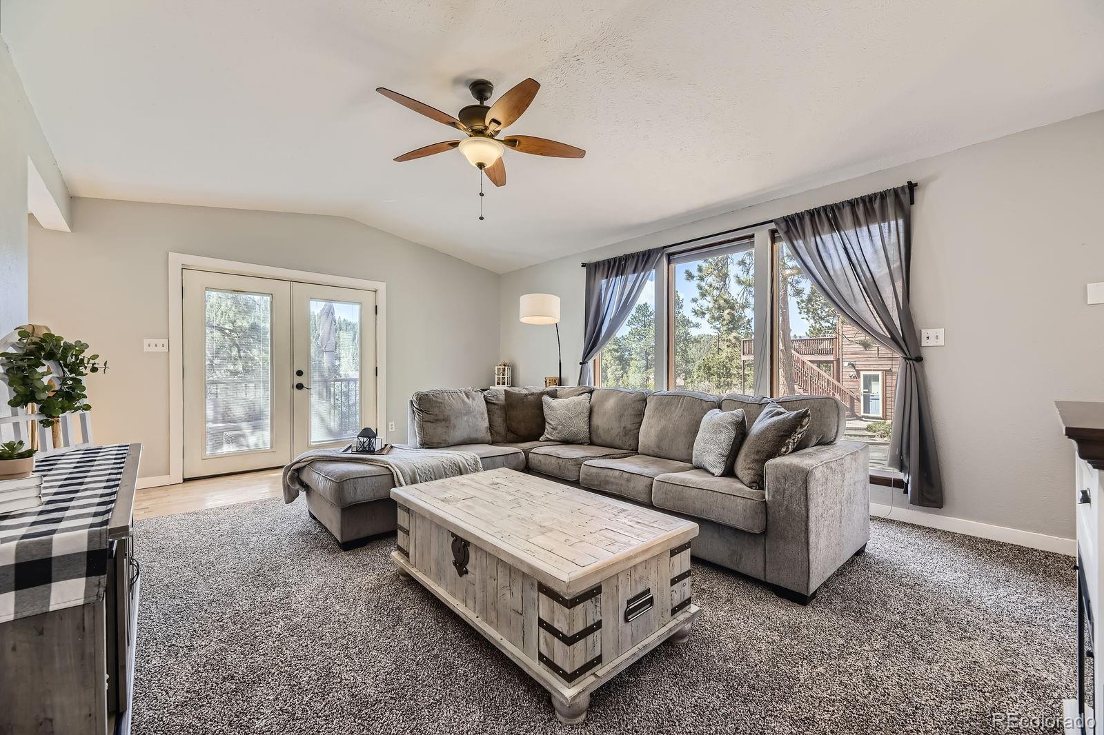 49 Silver Springs Road Bailey, CO 80421 - Photo 9 of 34 a living room with furniture and a large window