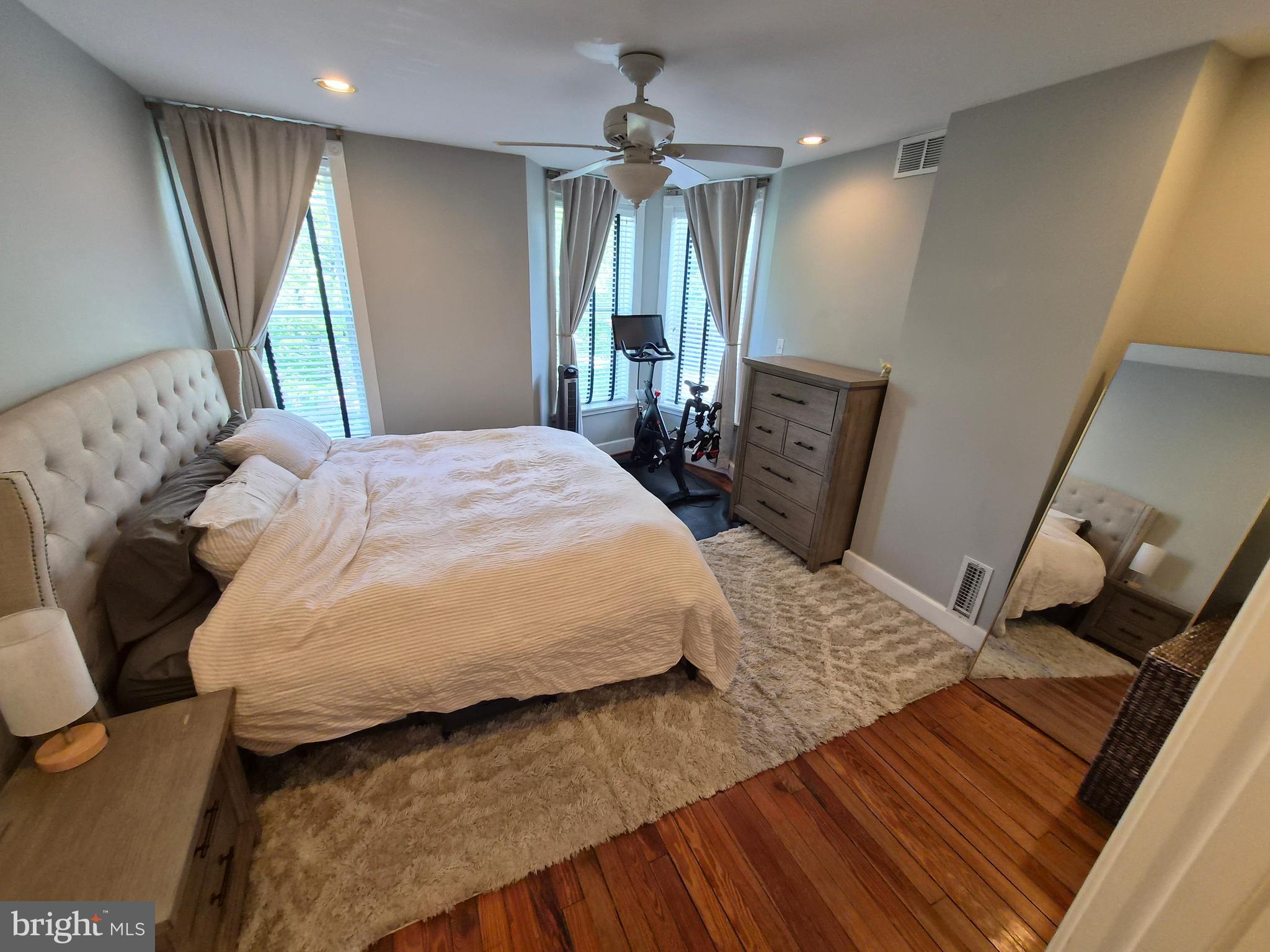 1601 Belt Street Baltimore, MD 21230 - Photo 18 of 30 a bedroom with a bed a dresser and wooden floor