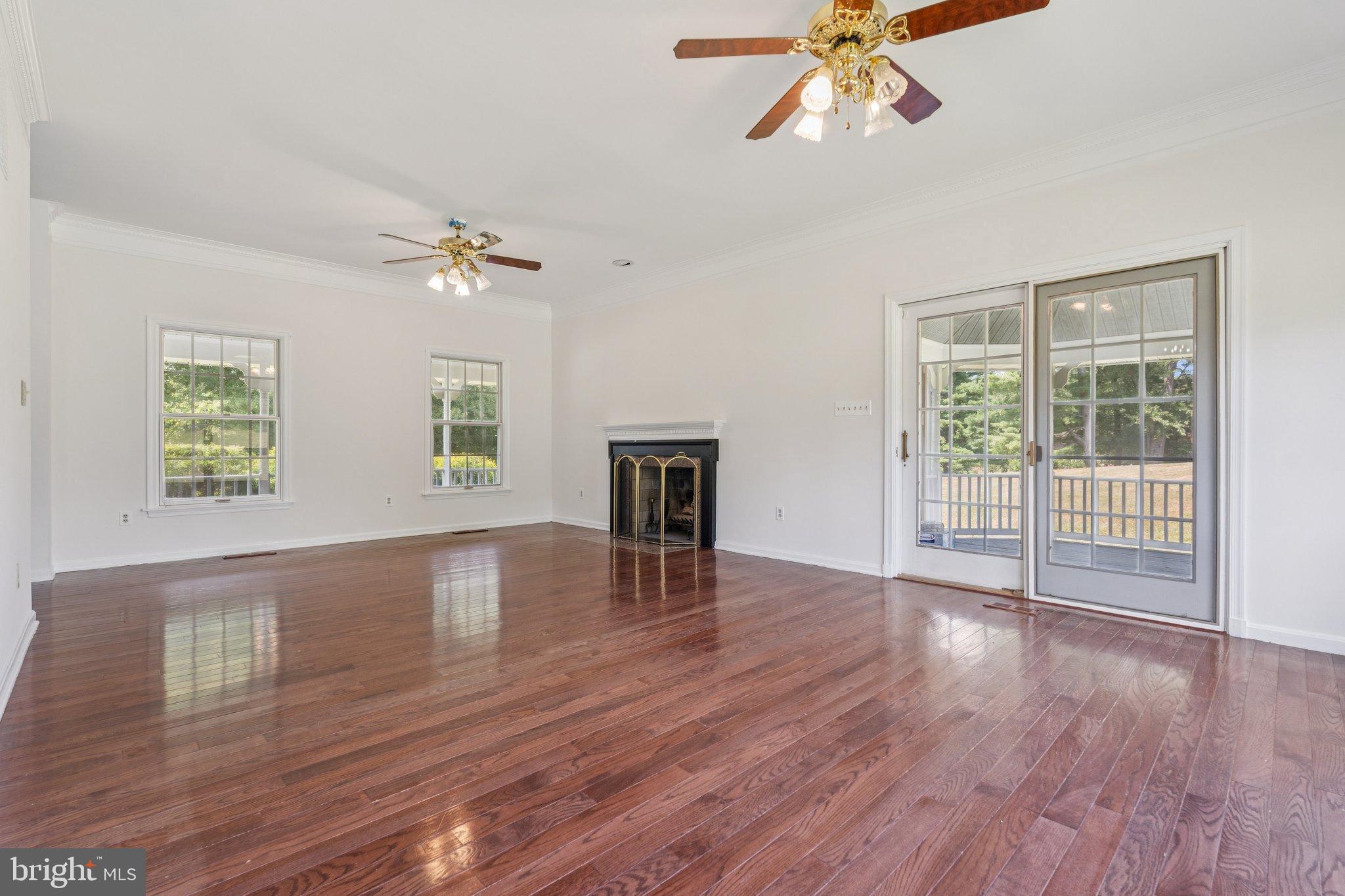 12212 Mt Albert Road Ellicott City, MD 21042 - Photo 11 of 58 a view of an empty room with wooden floor and a window