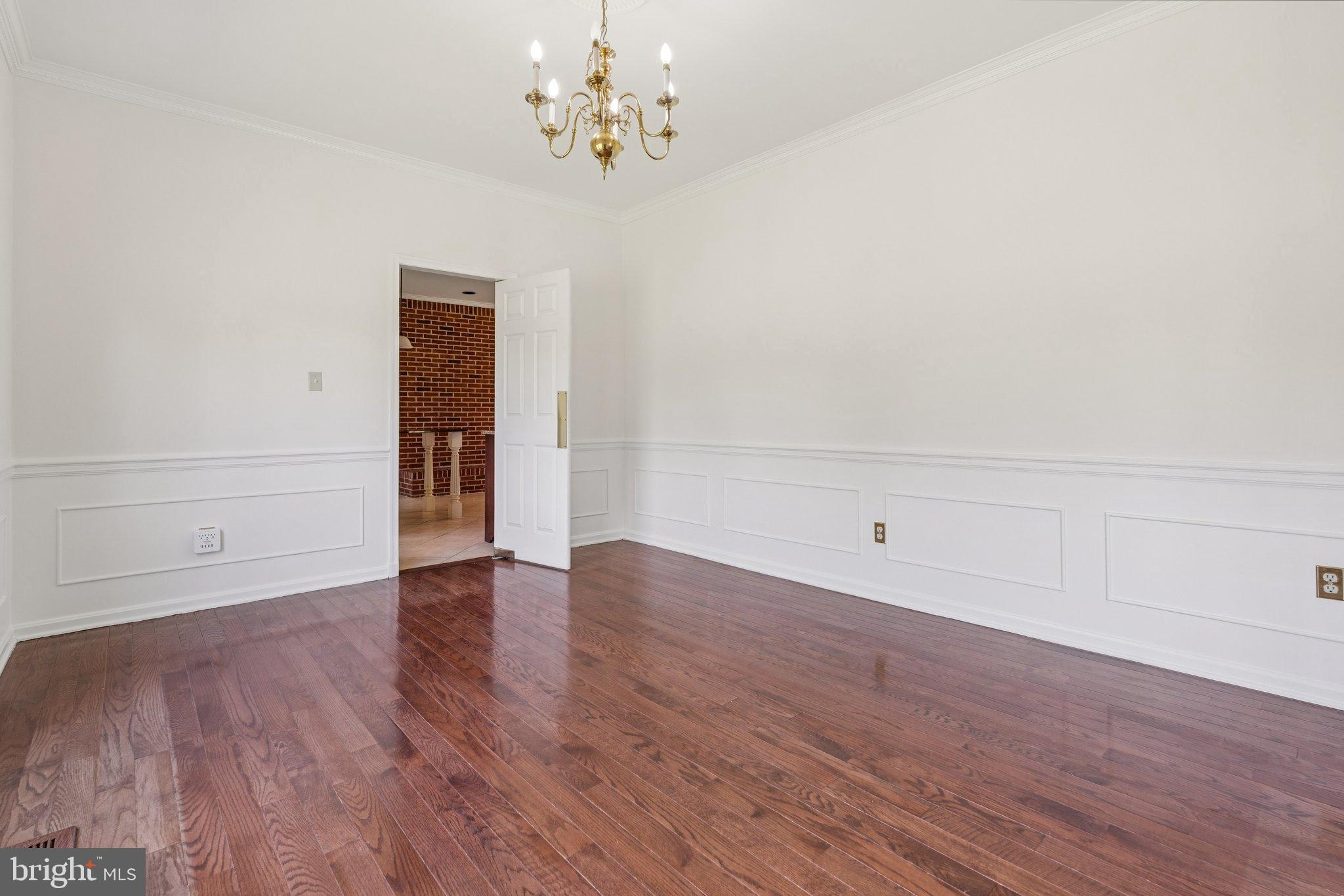 12212 Mt Albert Road Ellicott City, MD 21042 - Photo 13 of 58 a view of an empty room with wooden floor