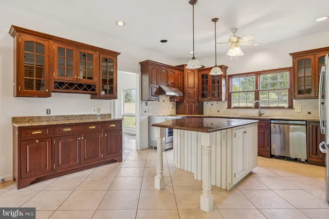 a kitchen with stainless steel appliances granite countertop a stove microwave and cabinets