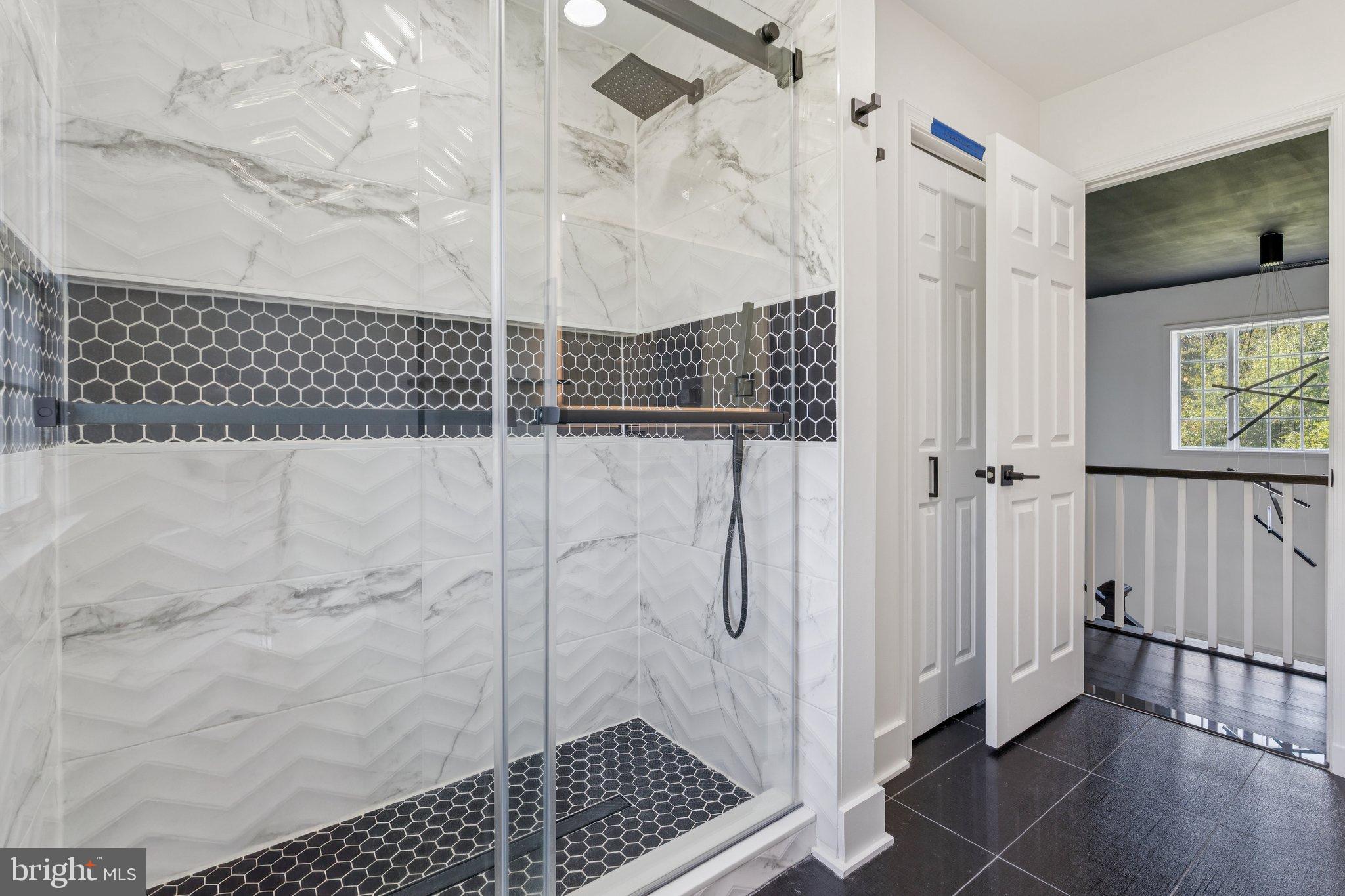 12212 Mt Albert Road Ellicott City, MD 21042 - Photo 22 of 58 Sleek modern shower with elegant tiles.