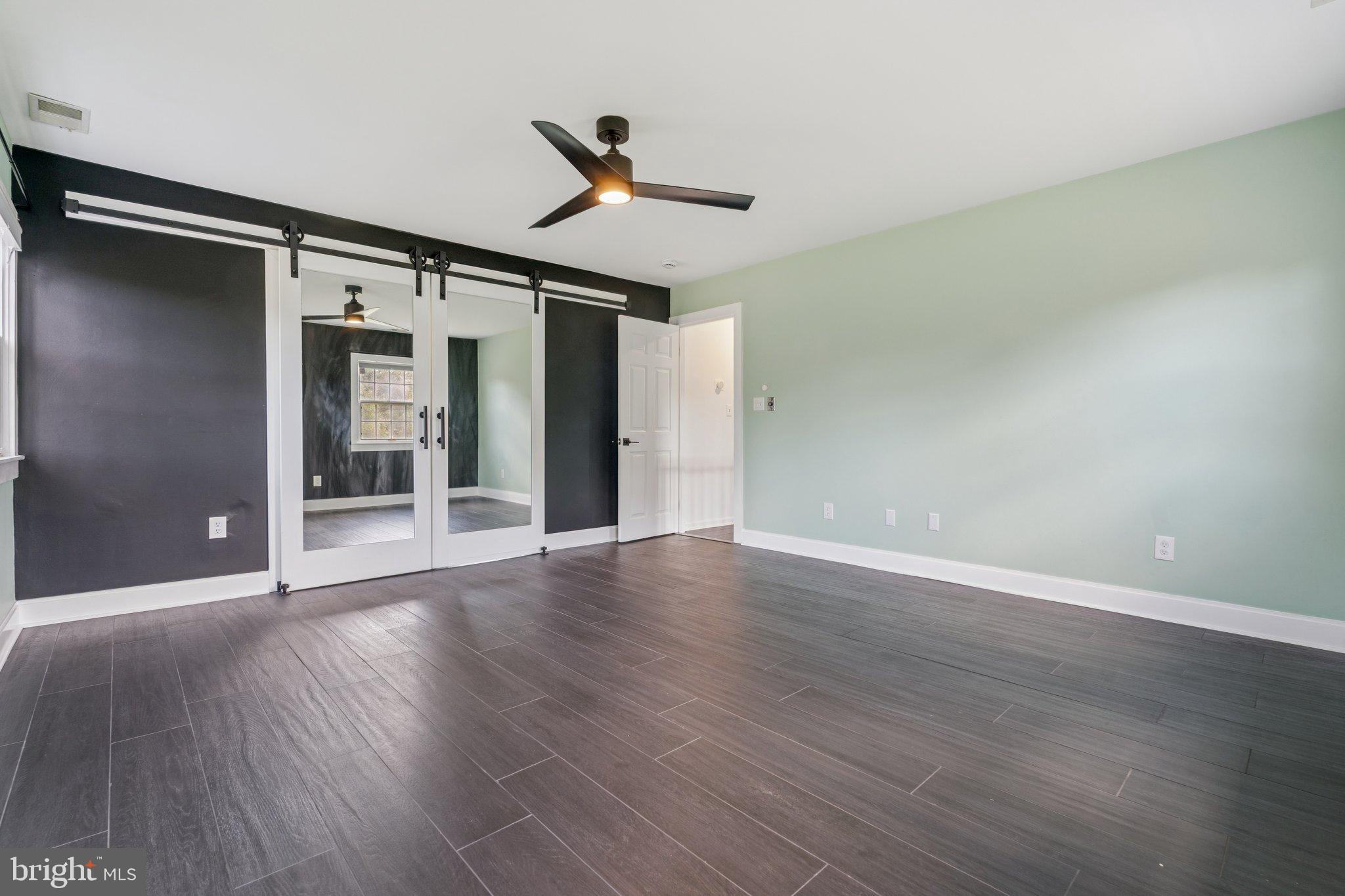 12212 Mt Albert Road Ellicott City, MD 21042 - Photo 26 of 58 a view of empty room with wooden floor