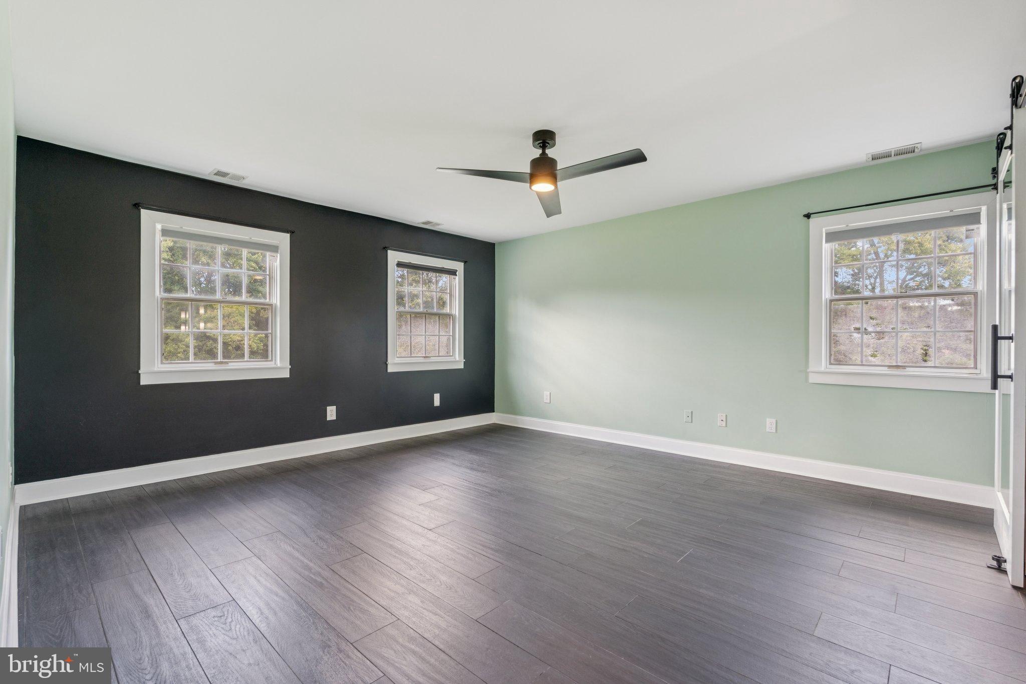 12212 Mt Albert Road Ellicott City, MD 21042 - Photo 27 of 58 a view of an empty room with wooden floor and a window
