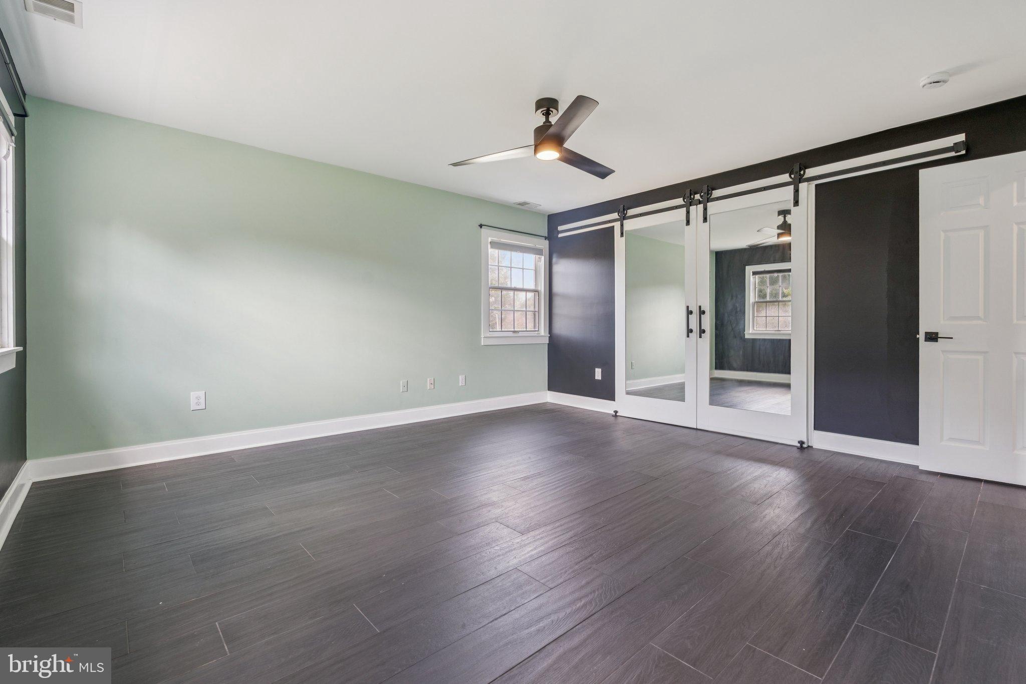 12212 Mt Albert Road Ellicott City, MD 21042 - Photo 28 of 58 a view of empty room with wooden floor and fan