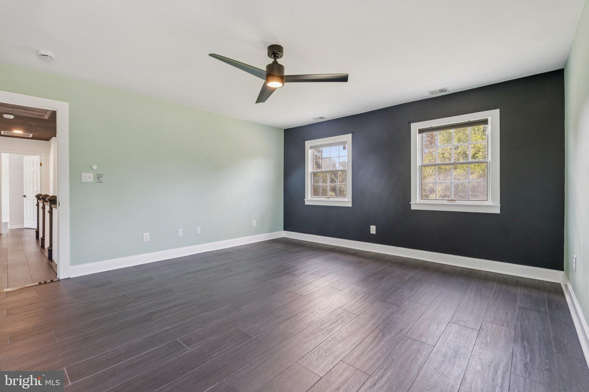 12212 Mt Albert Road Ellicott City, MD 21042 - Photo 29 of 58 a view of an empty room with wooden floor and a window