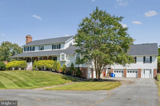 a front view of a house with a garden and plants