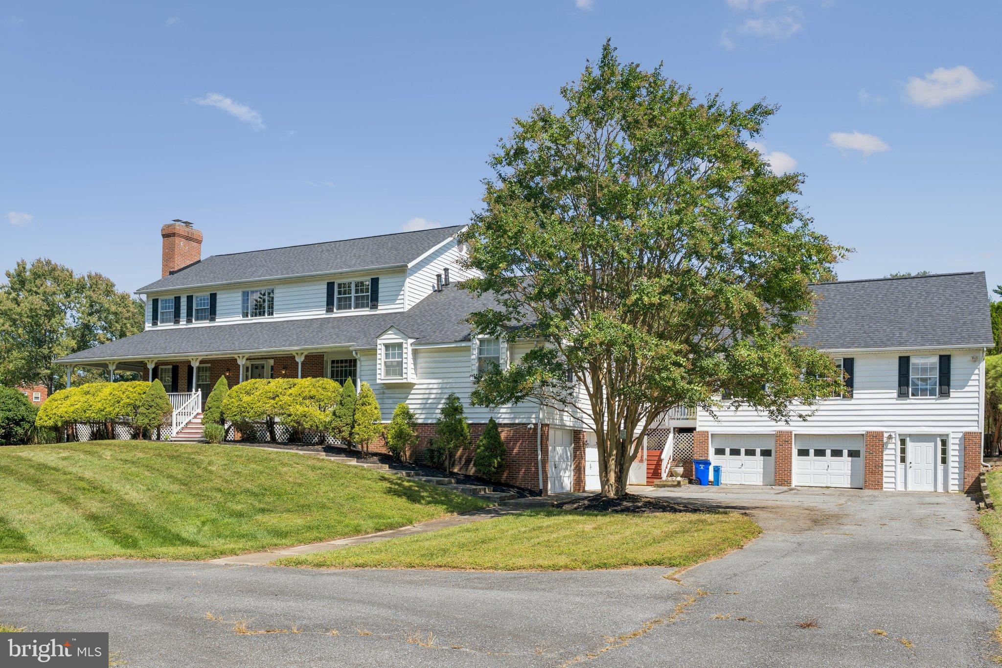 12212 Mt Albert Road Ellicott City, MD 21042 - Photo 3 of 58 a front view of a house with a garden and plants