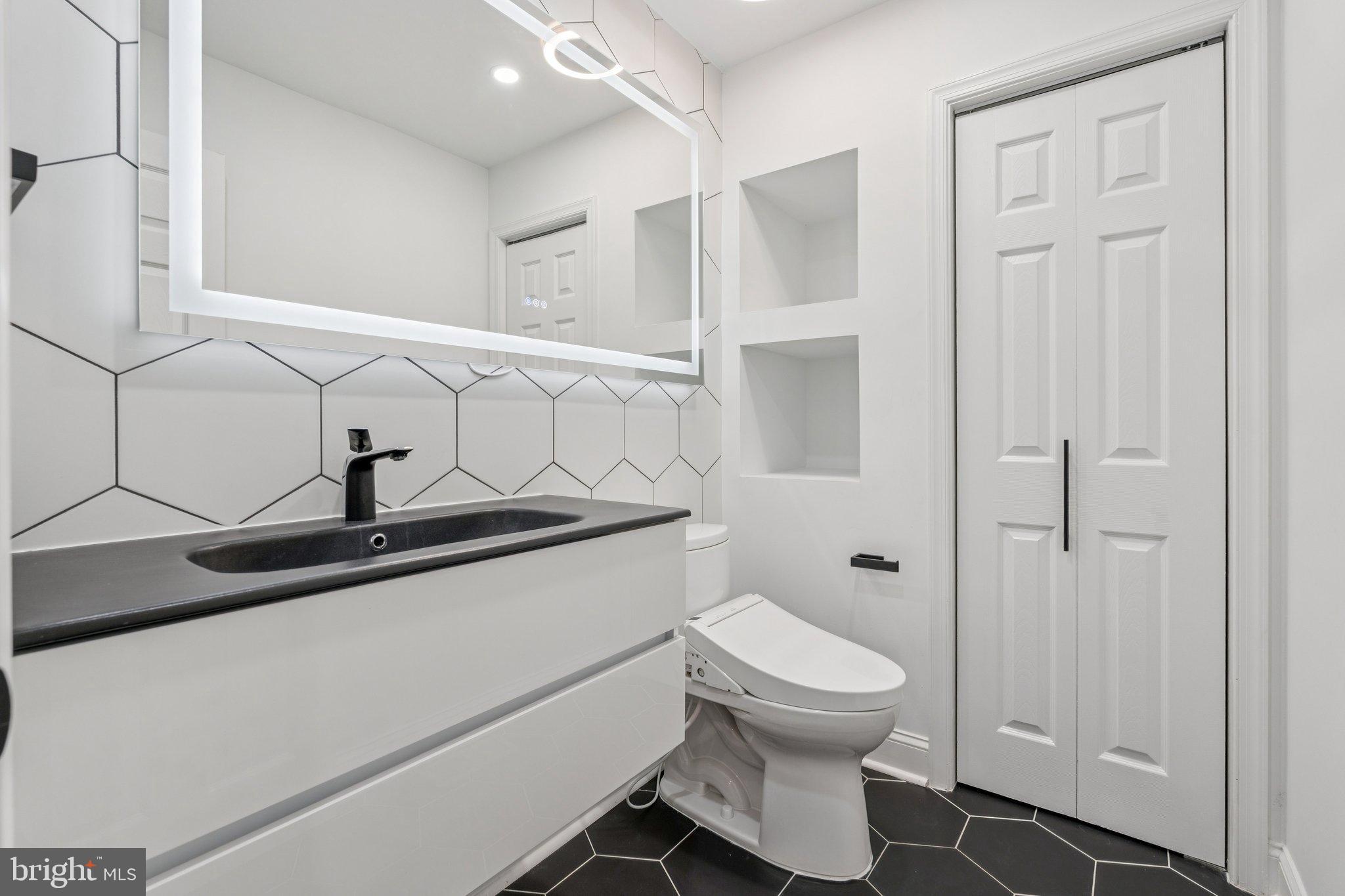 12212 Mt Albert Road Ellicott City, MD 21042 - Photo 31 of 58 a bathroom with a toilet a sink and mirror