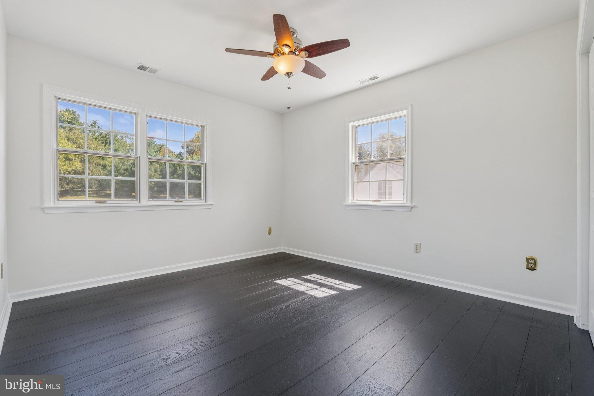 12212 Mt Albert Road Ellicott City, MD 21042 - Photo 36 of 58 a view of empty room with wooden floor and fan